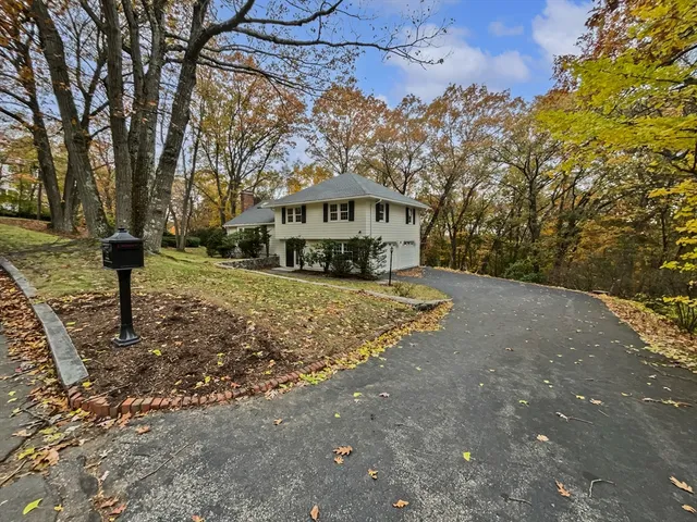 a front view of a house with a yard covered with snow in front of house