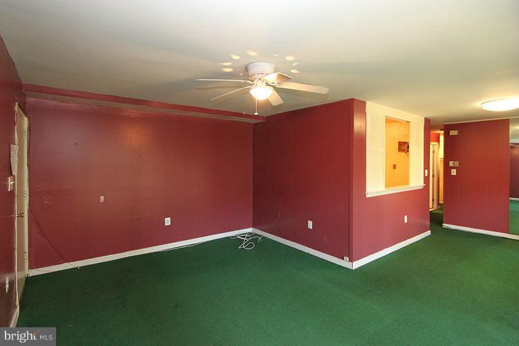 9282 Adelphi Road, Unit 102 Hyattsville, MD 20783 - Photo 1 of 29 a view of an empty room with window and chandelier fan