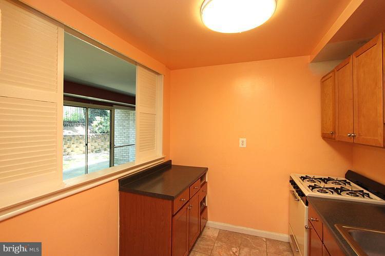 9282 Adelphi Road, Unit 102 Hyattsville, MD 20783 - Photo 3 of 29 a kitchen with a stove and a refrigerator