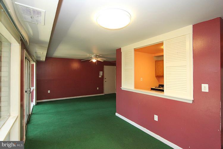 9282 Adelphi Road, Unit 102 Hyattsville, MD 20783 - Photo 23 of 29 a view of a livingroom with furniture and a window
