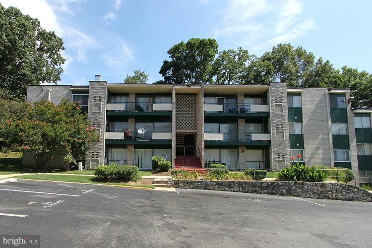 9282 Adelphi Road, Unit 102 Hyattsville, MD 20783 - Photo 28 of 29 a front view of a residential apartment building with a yard