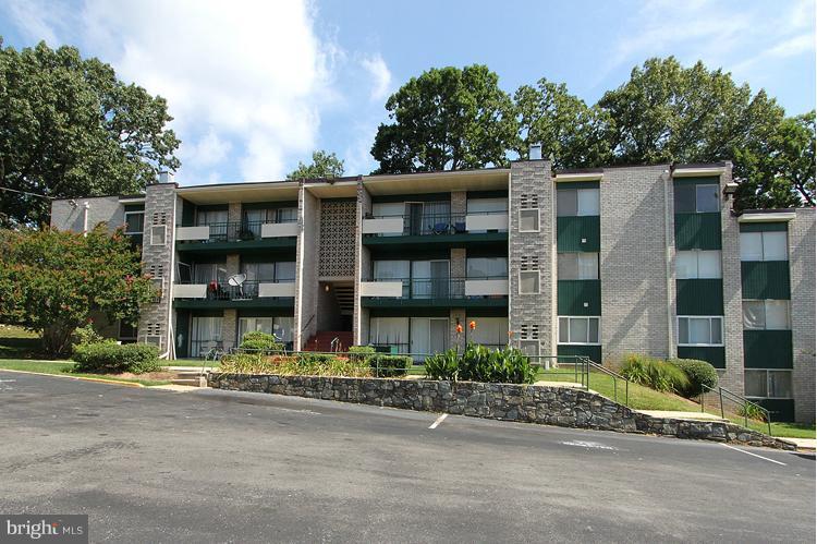 9282 Adelphi Road, Unit 102 Hyattsville, MD 20783 - Photo 29 of 29 a front view of a residential apartment building with a yard