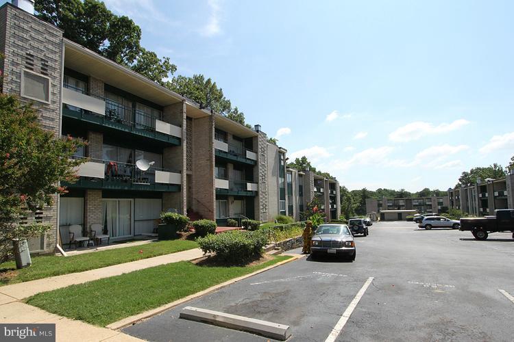 9282 Adelphi Road, Unit 102 Hyattsville, MD 20783 - Photo 4 of 29 a view of road with card parked on side and retail shops
