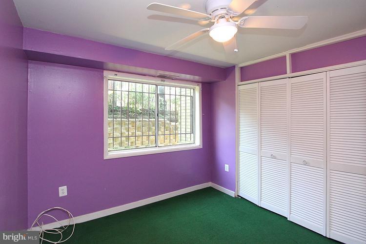 9282 Adelphi Road, Unit 102 Hyattsville, MD 20783 - Photo 6 of 29 a view of an empty room with window and a ceiling fan