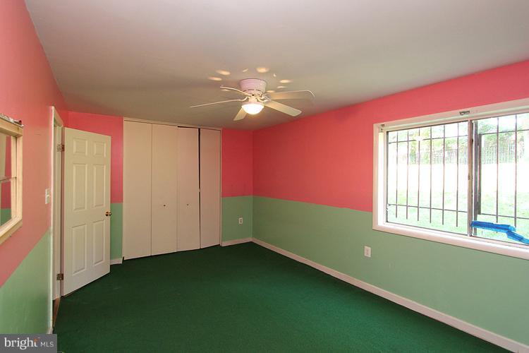 9282 Adelphi Road, Unit 102 Hyattsville, MD 20783 - Photo 7 of 29 a room with window and ceiling fan