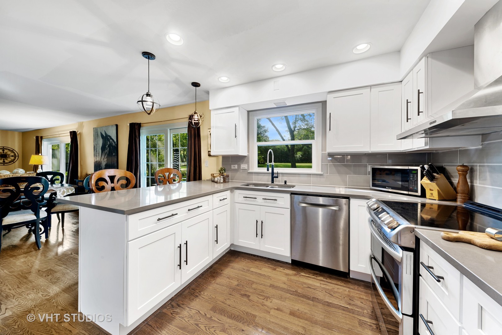 205 Cold Spring Road Barrington, IL 60010 - Photo 5 of 21 a kitchen with stainless steel appliances granite countertop a stove top oven a sink a dining table and chairs