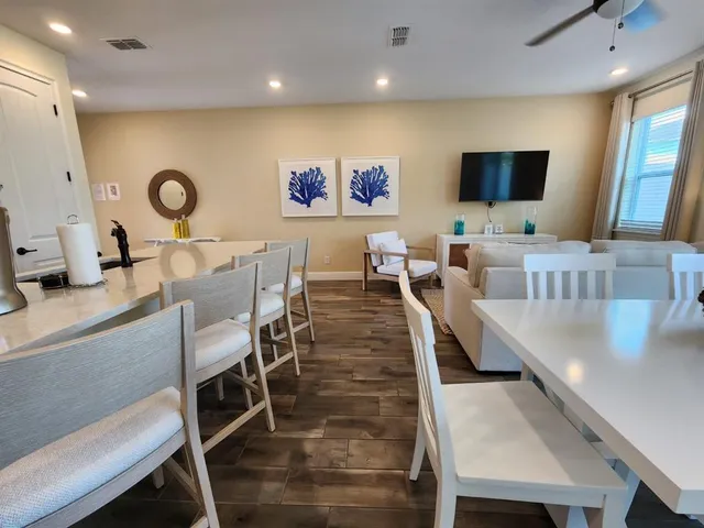 a front view of a house with a yard and trees