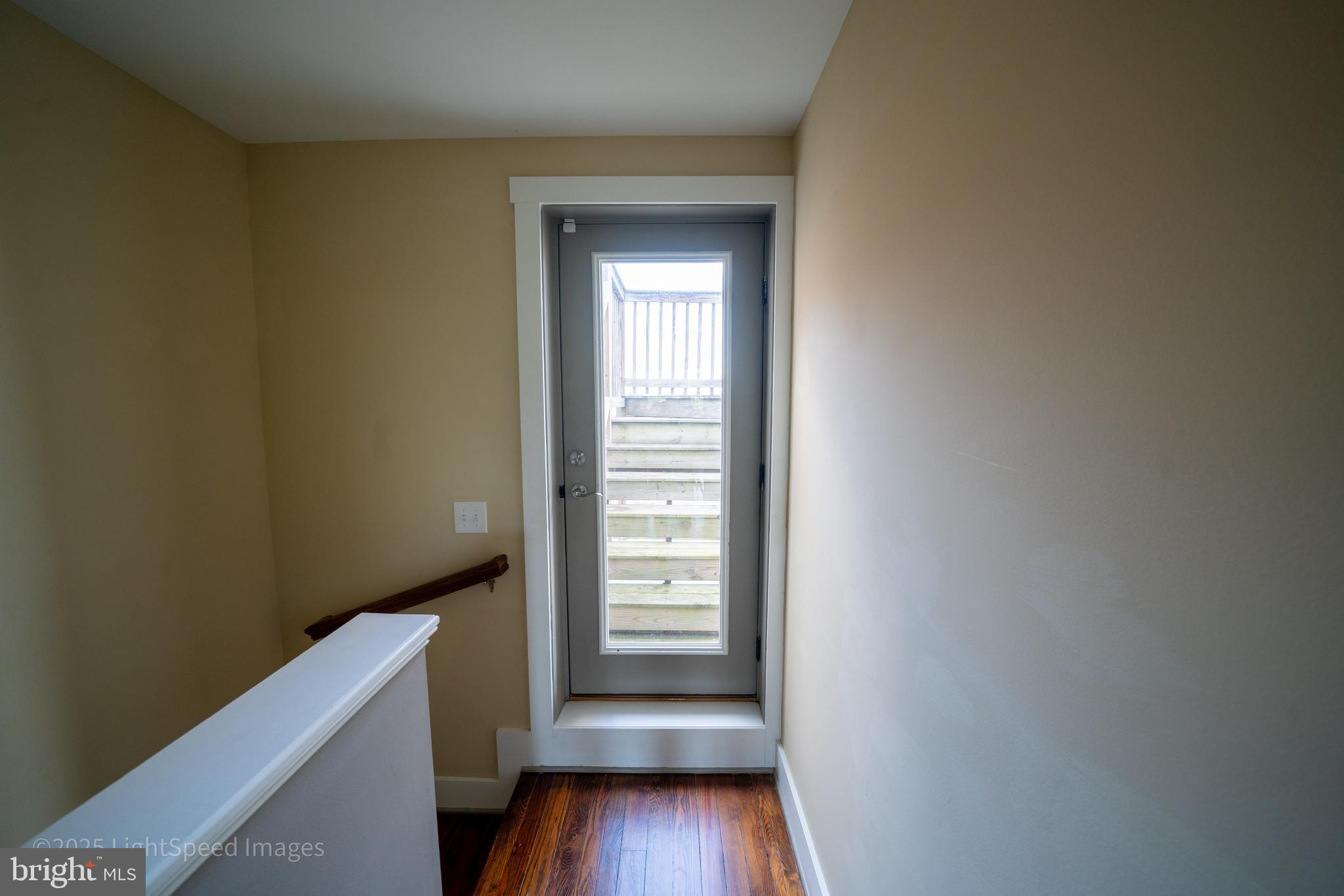 2730 East Baltimore Street Baltimore, MD 21224 - Photo 11 of 40 a view of an empty room with wooden floor and a window