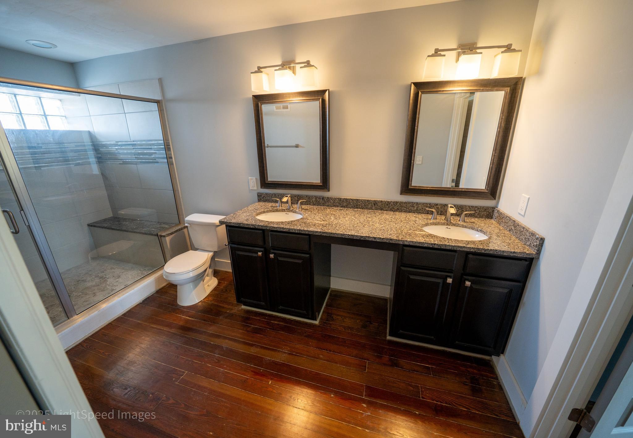2730 East Baltimore Street Baltimore, MD 21224 - Photo 16 of 40 a bathroom with a sink a toilet a mirror and shower