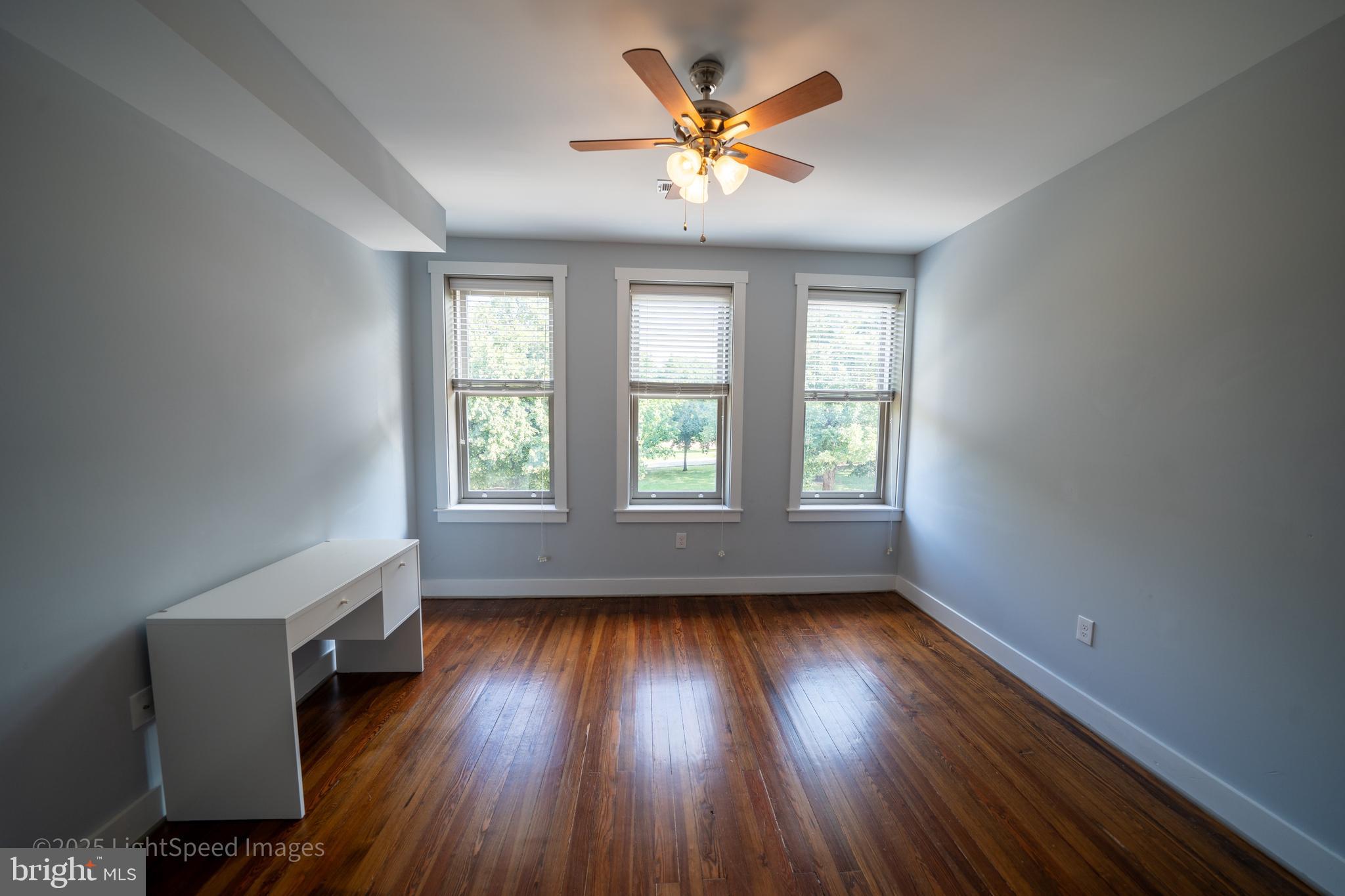 2730 East Baltimore Street Baltimore, MD 21224 - Photo 20 of 40 an empty room with wooden floor and windows