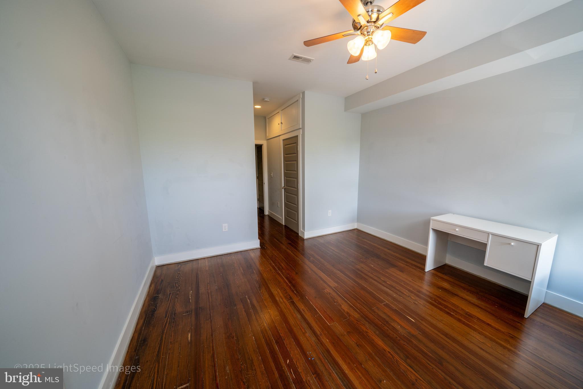 2730 East Baltimore Street Baltimore, MD 21224 - Photo 21 of 40 a view of a room with wooden floor and ceiling fan