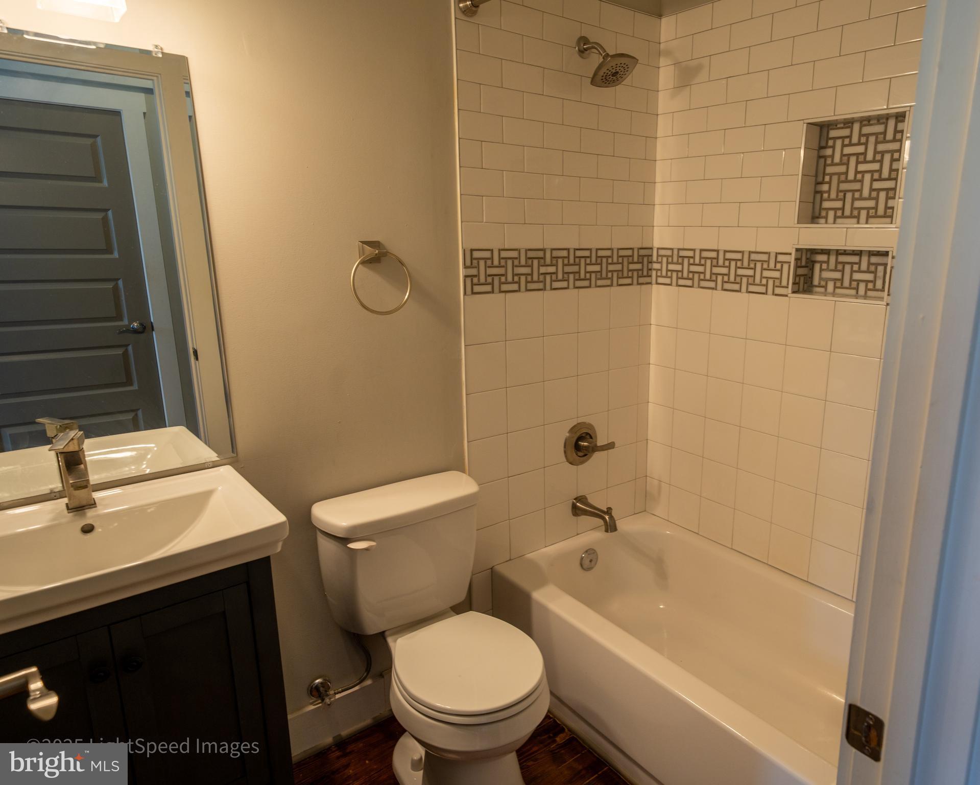 2730 East Baltimore Street Baltimore, MD 21224 - Photo 22 of 40 a bathroom with a sink a toilet and shower