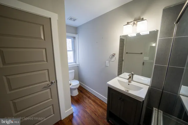 a bathroom with a shower sink and mirror