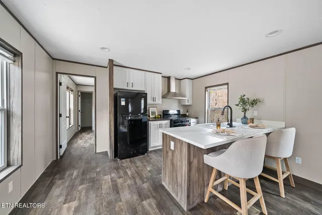 a kitchen with refrigerator cabinets dining table and chairs