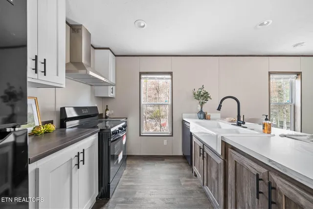 a kitchen with a sink stove and cabinets