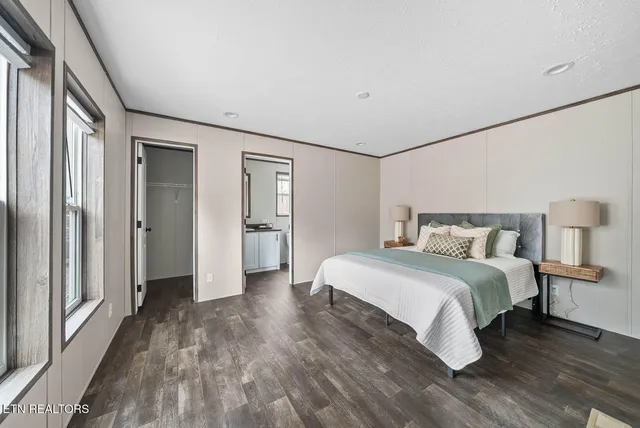 a spacious bedroom with a bed and a mirror