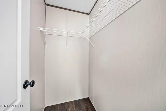 a view of a room with wooden floor