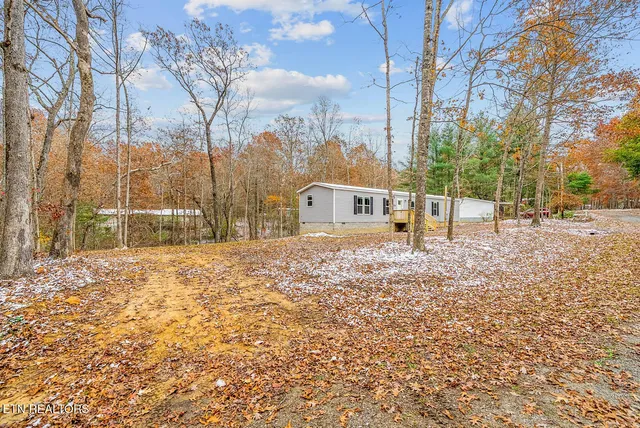 a backyard of a house with large trees