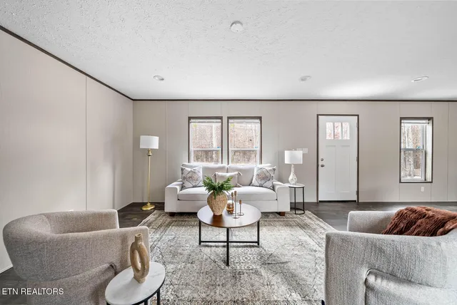 a living room with furniture and a large window