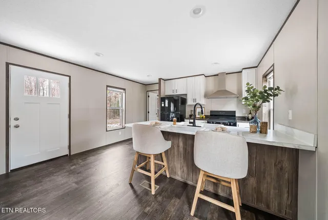 a kitchen with a table and chairs in it
