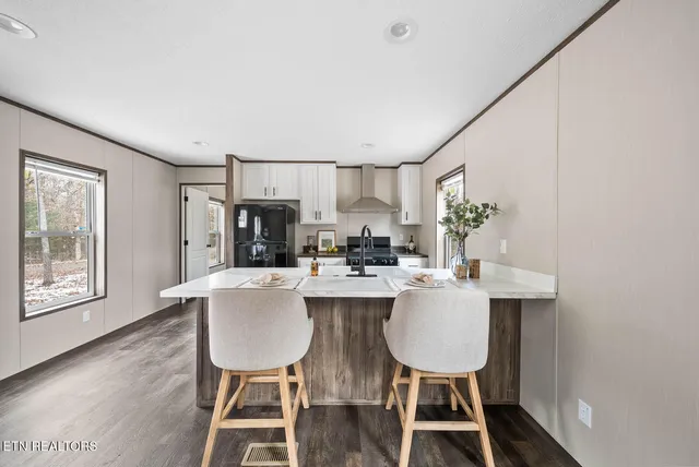 a kitchen with a table and chairs