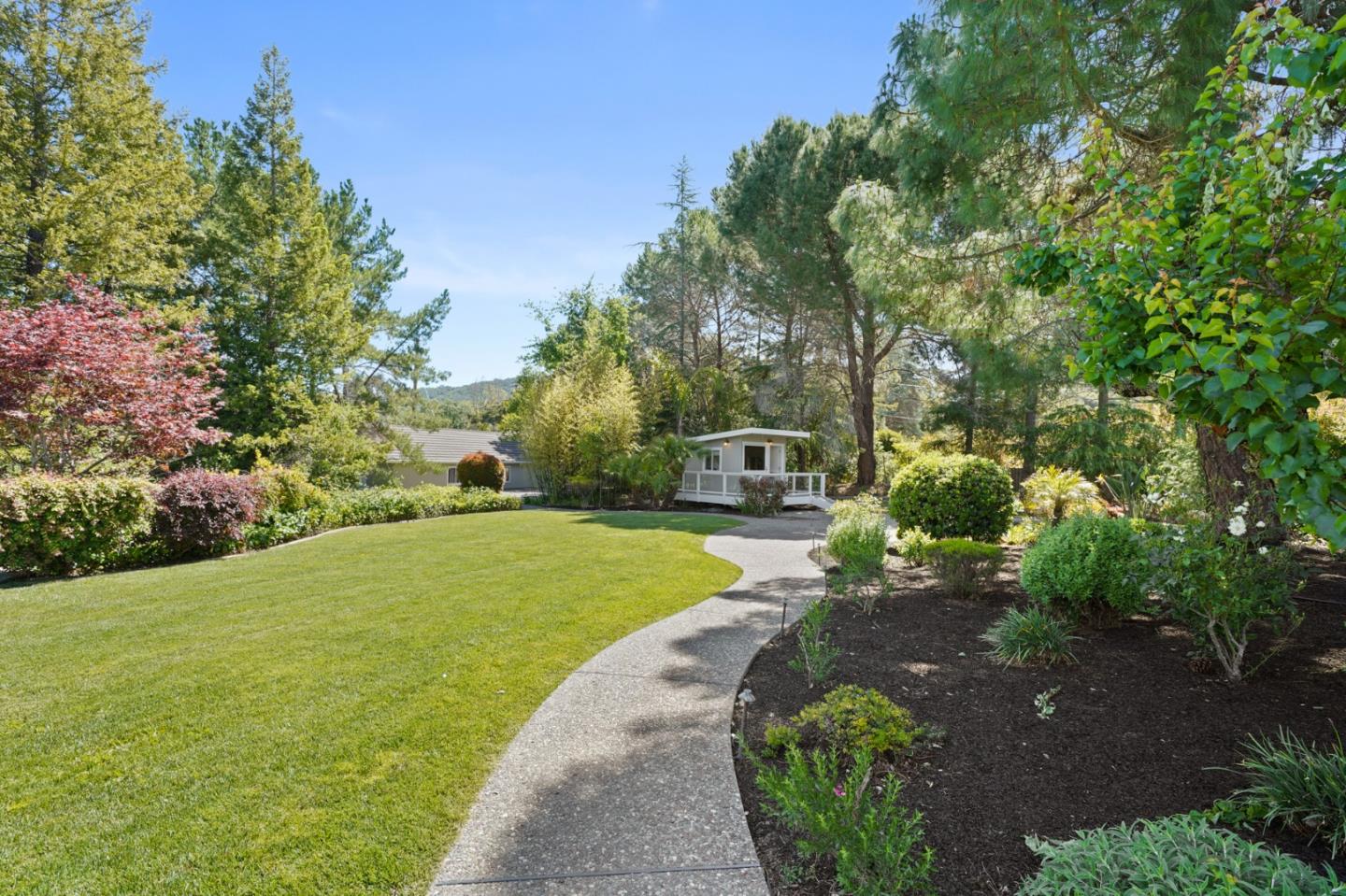 15 Debes Ranch Road San Rafael, CA 94903 - Photo 33 of 45 a view of a garden with lawn chairs under an umbrella