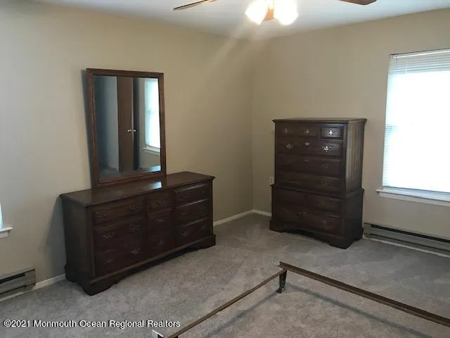 a room with a dresser and a window