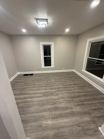 a view of a room with wooden floor and stairs