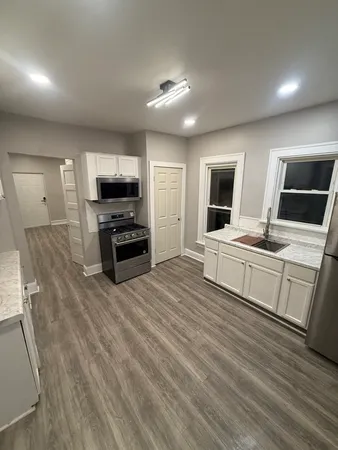a view of a room with wooden floor and stairs