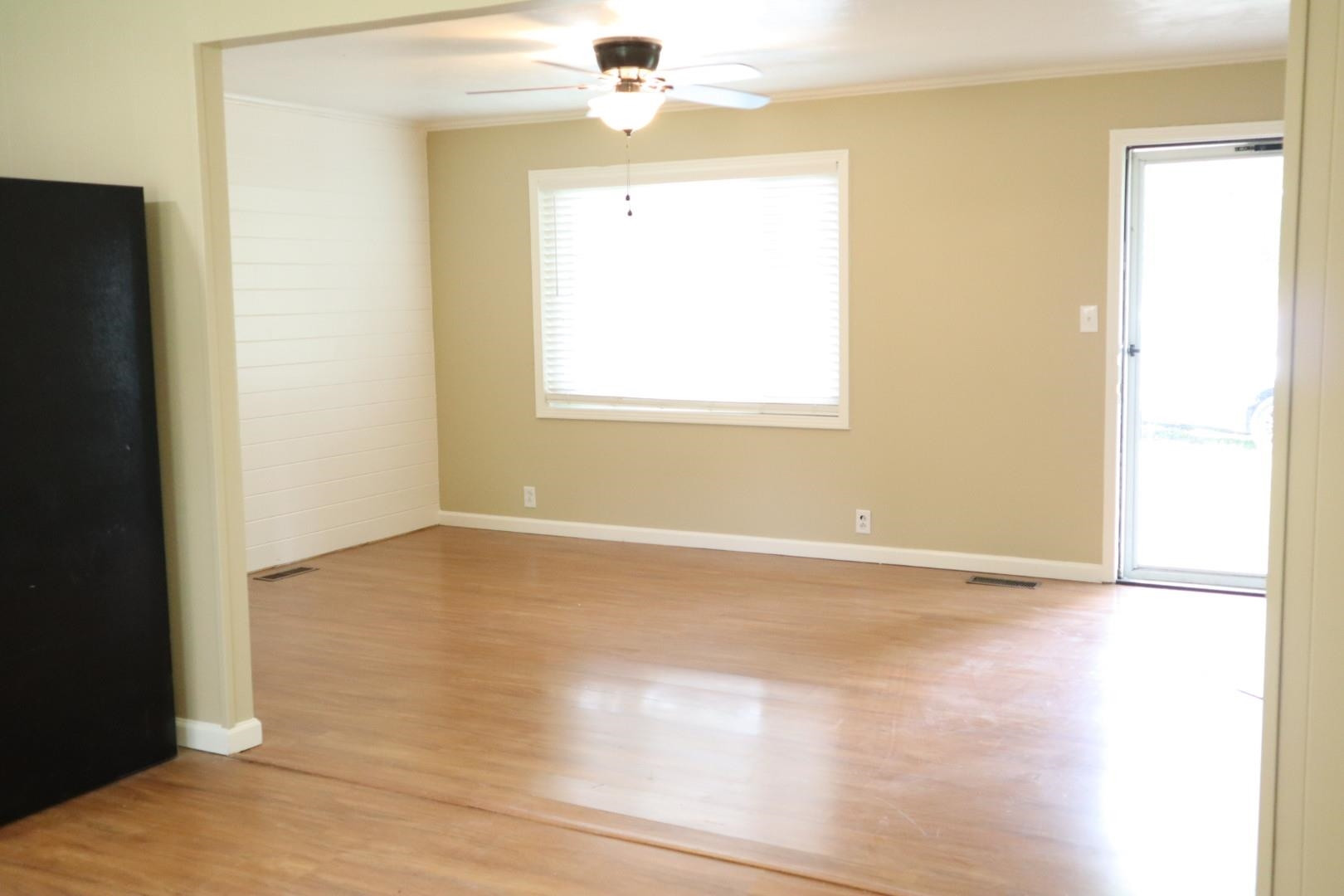 1801 Bailey Road Gadsden, TN 38337 - Photo 5 of 15 a view of an empty room with wooden floor and a window