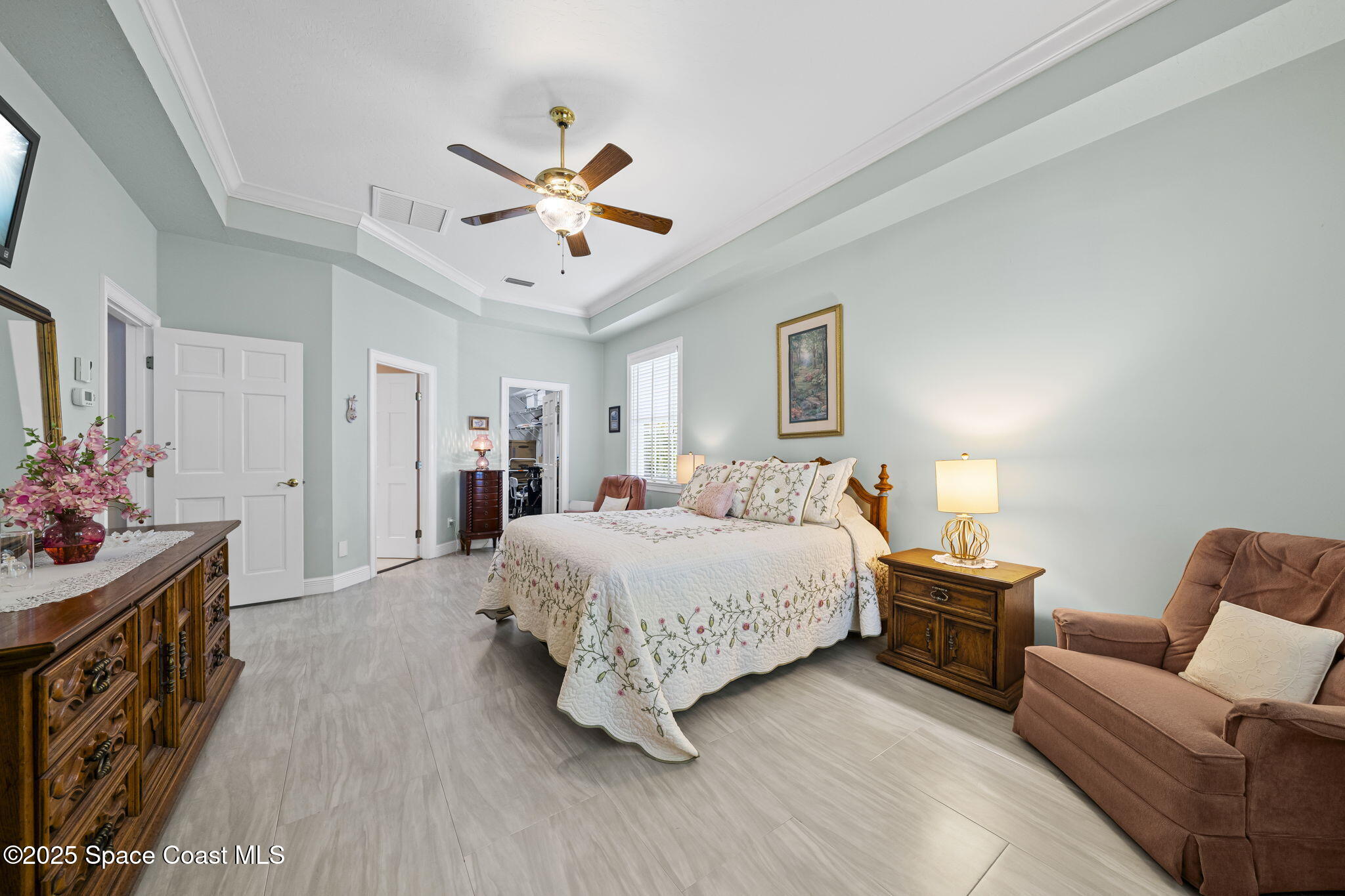 1407 Rockledge Drive Rockledge, FL 32955 - Photo 3 of 79 a bedroom with a bed chandelier and a couch