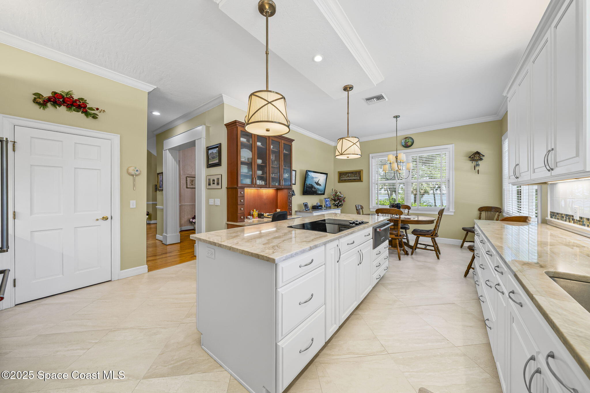 1407 Rockledge Drive Rockledge, FL 32955 - Photo 49 of 79 a large kitchen with kitchen island a stove a sink a center island and living room view