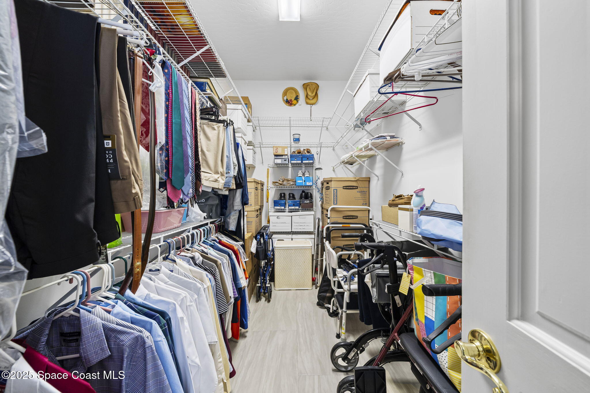 1407 Rockledge Drive Rockledge, FL 32955 - Photo 53 of 79 a view of walk in closet with clothes
