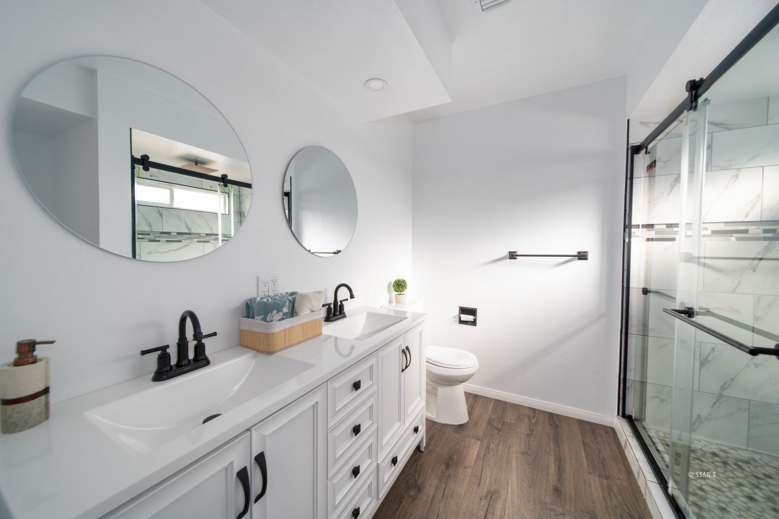 1965 South Downs Street Ridgecrest, CA 93555 - Photo 19 of 31 a bathroom with a double vanity sink mirror and toilet