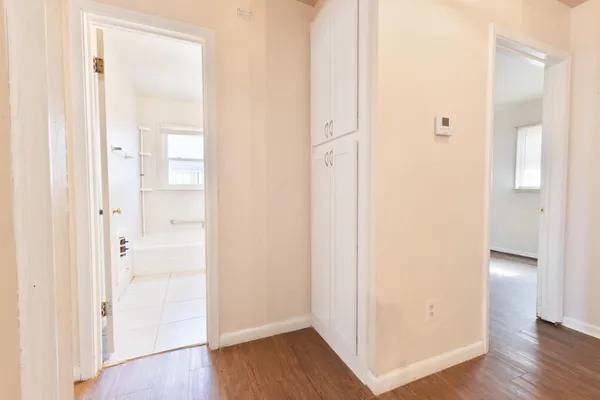 a view of a hallway with wooden floor
