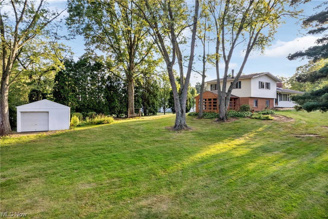 120 Lester Road New Franklin, OH 44319 - Photo 2 of 24 View of yard featuring garage