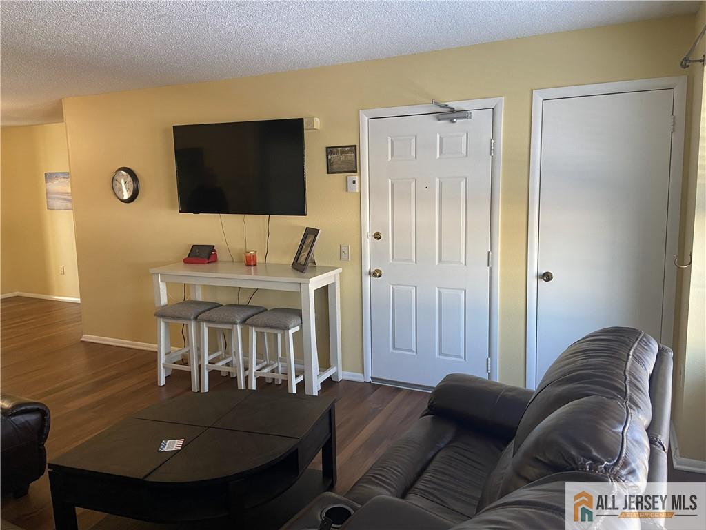 525 Belford Road, Unit O Monroe Township, NJ 08831 - Photo 2 of 19 a living room with furniture and a flat screen tv
