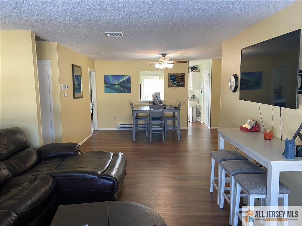 525 Belford Road, Unit O Monroe Township, NJ 08831 - Photo 3 of 19 a living room with furniture and a flat screen tv