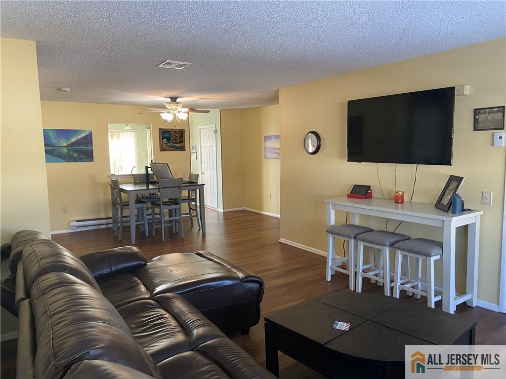 525 Belford Road, Unit O Monroe Township, NJ 08831 - Photo 4 of 19 a living room with furniture and a flat screen tv