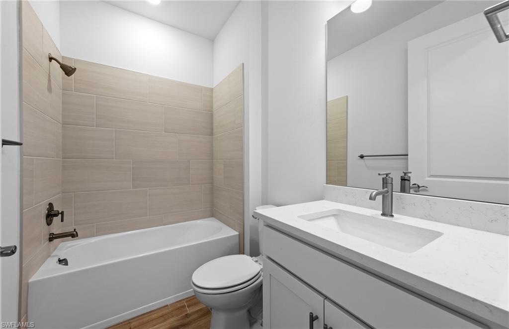 12464 Basalt Lane Alva, FL 33920 - Photo 19 of 28 a bathroom with a sink a toilet and a bathtub