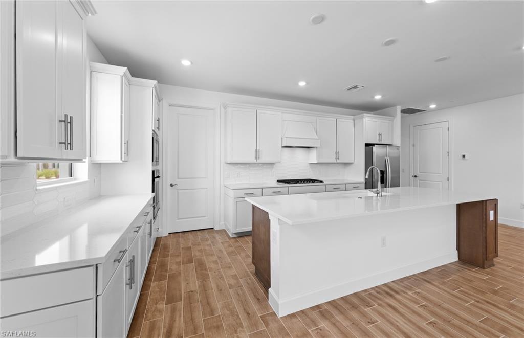 12464 Basalt Lane Alva, FL 33920 - Photo 8 of 28 a kitchen with kitchen island a sink stove and refrigerator