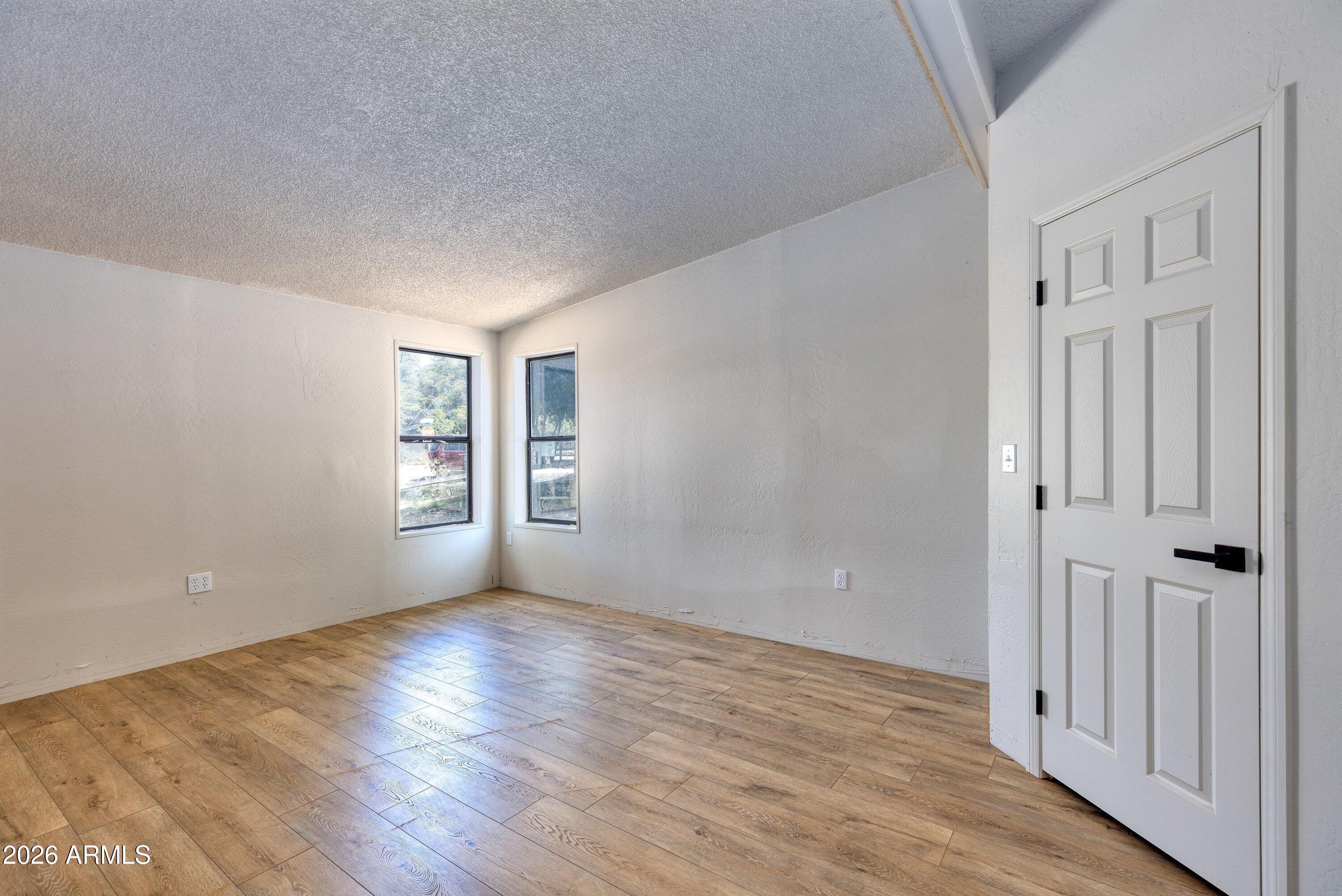 1302 North Matterhorn Road Payson, AZ 85541 - Photo 11 of 27 a view of an empty room with wooden floor and a window