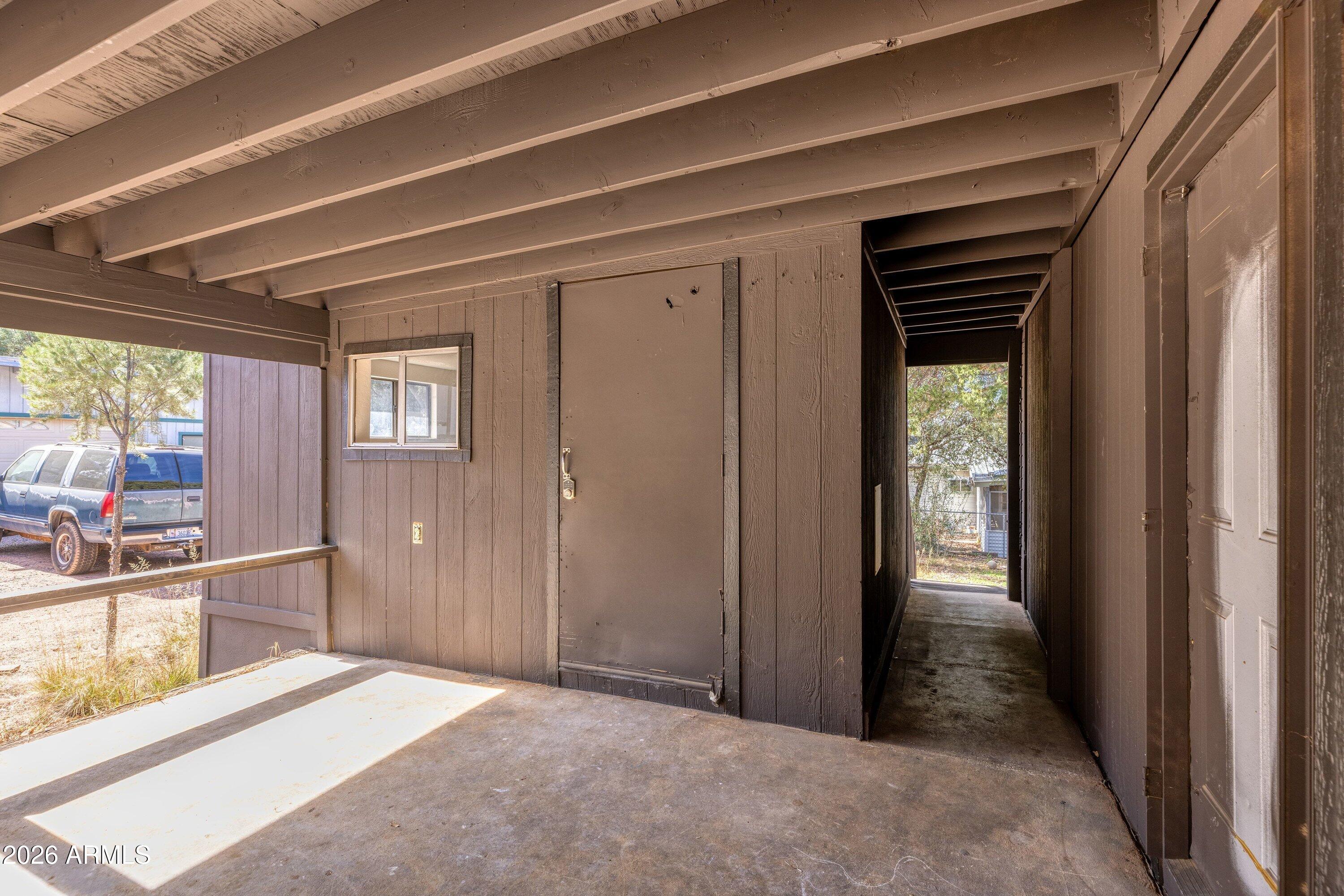 1302 North Matterhorn Road Payson, AZ 85541 - Photo 21 of 27 a view of a hallway with wooden floor and windows
