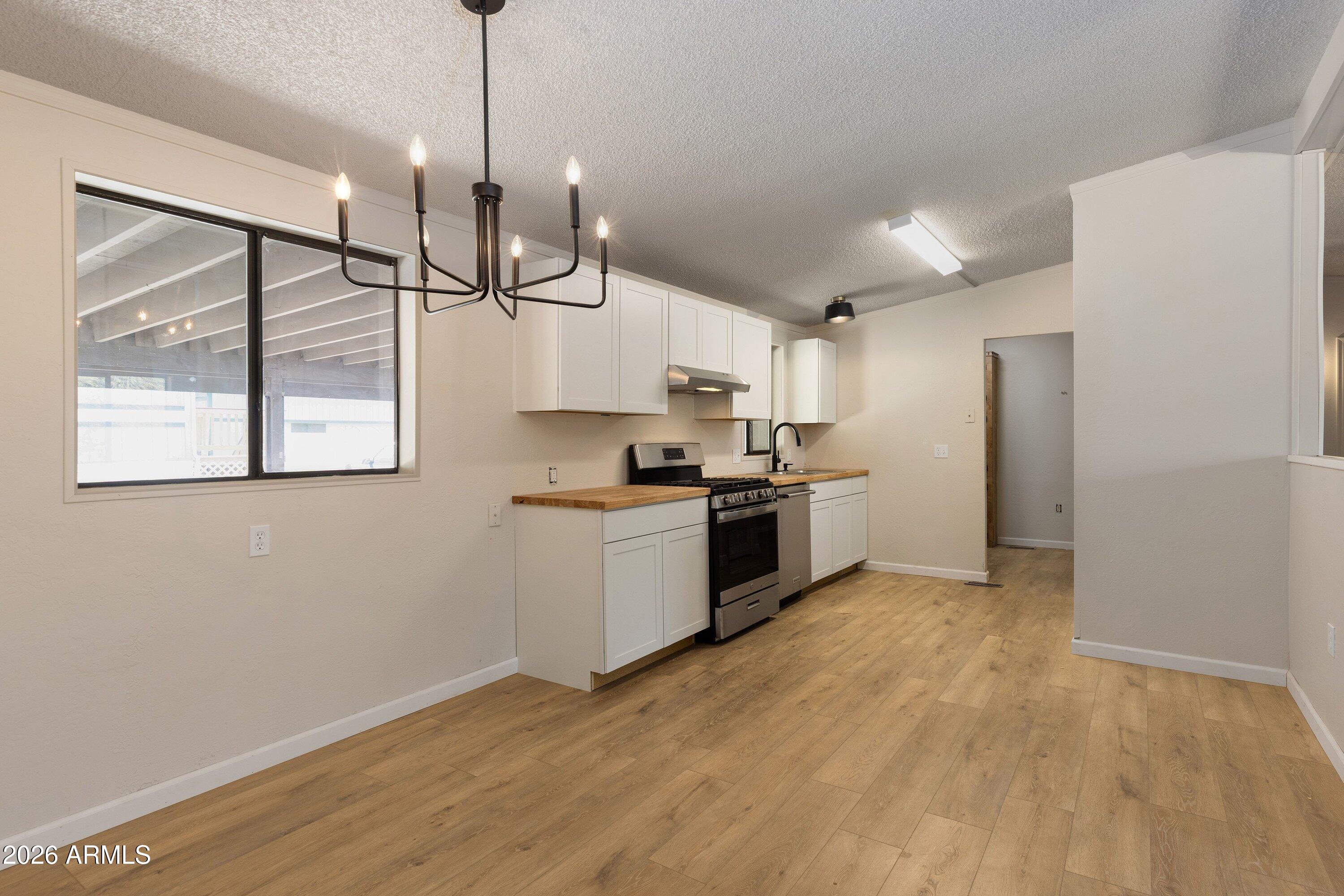 1302 North Matterhorn Road Payson, AZ 85541 - Photo 8 of 27 a kitchen with stainless steel appliances granite countertop a stove a sink and a refrigerator