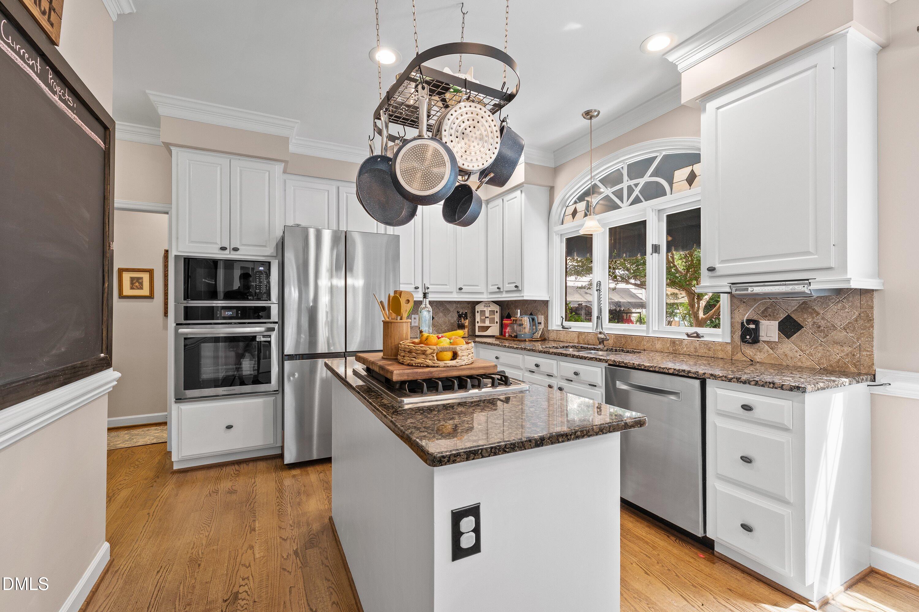 6612 Fowler Road Zebulon, NC 27597 - Photo 8 of 42 a kitchen with stainless steel appliances granite countertop a stove and a sink