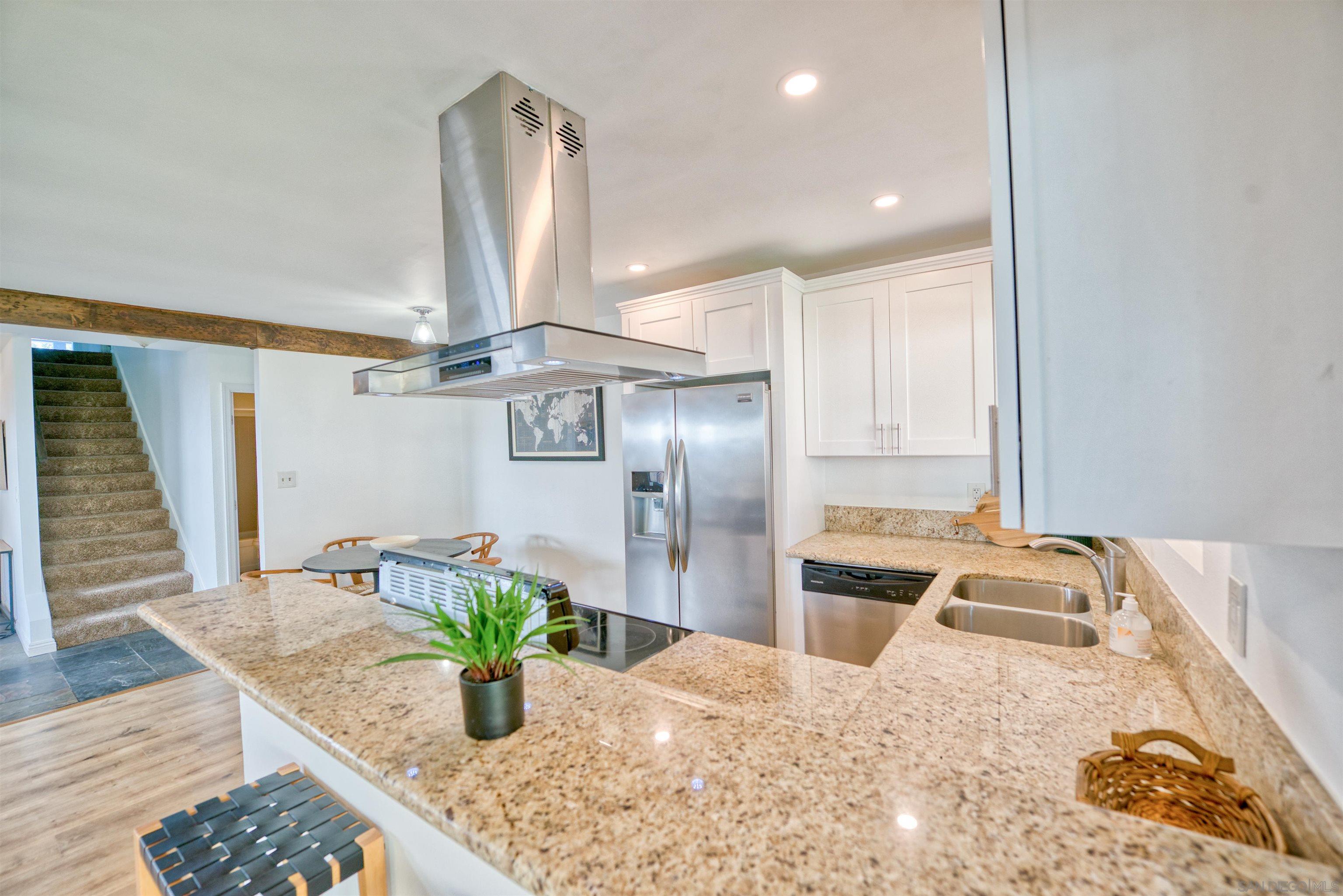 a kitchen with stainless steel appliances kitchen island granite countertop a counter top space cabinets and wooden floor