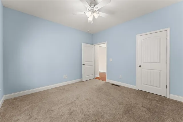 a view of room with a ceiling fan and window