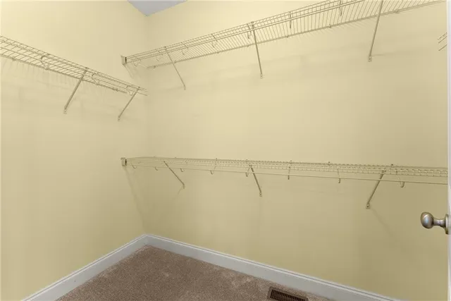 a view of an empty room with wooden roof