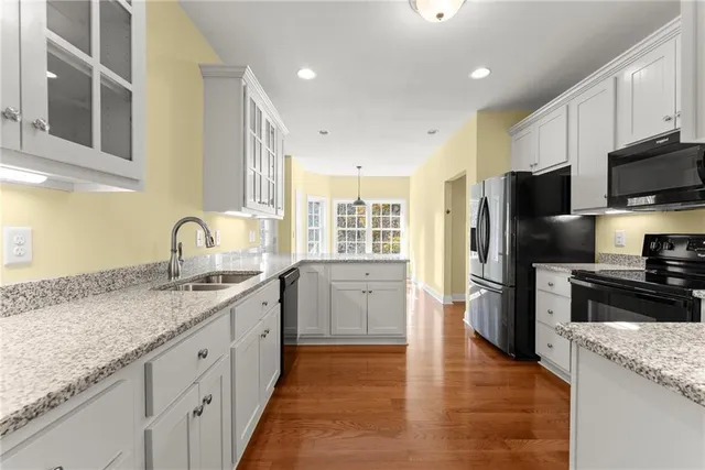 a kitchen with granite countertop a refrigerator stove and microwave