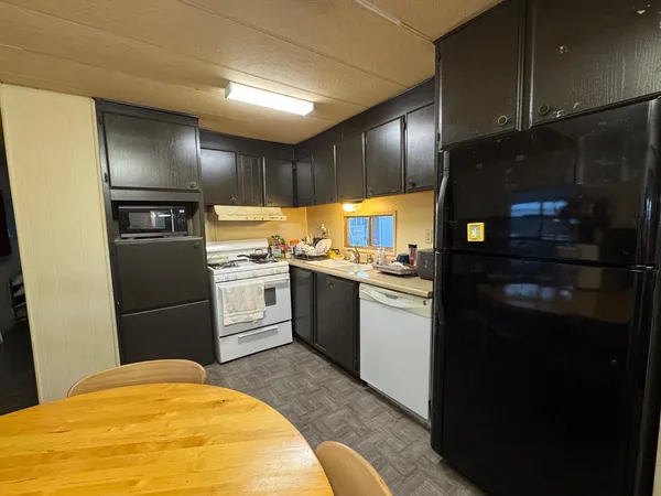 a kitchen with granite countertop stainless steel appliances and counter space